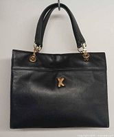 Front view showing gold X emblem and handles