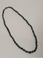 Full view of jade nugget bead necklace laid flat