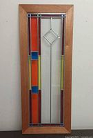 Full front view of the framed leaded glass panel showing overall design and frame