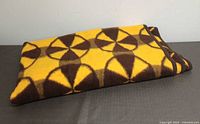 Folded yellow and brown geometric acrylic blanket