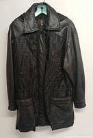 Front view of black Fendi Zucca hooded long coat on hanger