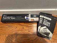 Box of HomeDeco blackboard wall stickers with two packs of Pencil Buddies sketching pencils