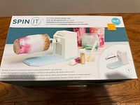 Front of box showing Spin It rotary drying tool and features