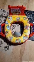 Top view showing Paw Patrol graphics, cushion, handles, sound board