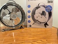 Fan front view beside retail box