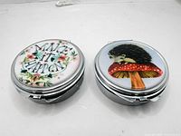 Both pill boxes closed, showing lid artwork