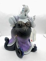 Full front view of Ursula figurine showing gown, tentacles and attached tag