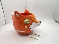 Left side view showing full fox planter profile and attached tag