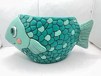 Left side view of teal fish planter showing scales and tail