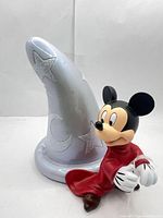 Front view of figurine showing Mickey Mouse and front of sorcerer hat