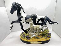 Full view of figurine showing mare, foal and base with title plaque