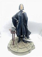 Front view of figurine showing Snape, base, table, cauldron, potion bottle
