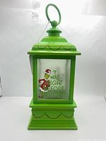 Front view of green lantern showing Grinch graphic and text