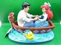 Full view of figurine showing boat, characters and base