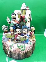 Front view of entire figurine showing all characters and house