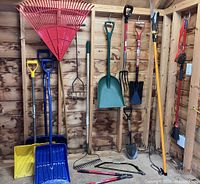 Overview of all yard tools hanging and standing in shed