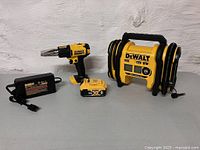 Group view of inflator, heat gun, battery, and AC adapter