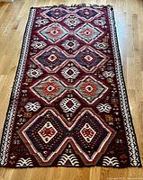 Full view of hand-woven Kilim rug showing overall pattern and colours