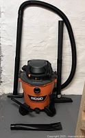 Full view of Ridgid HD16100 vacuum with hose, extension wands and attachments
