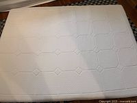 Top view of white quilted mattress topper