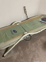Full view of Ceragem CGM-M3500 bed on carpet with remote and manuals
