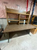 Front view of laminate desk with attached shelving hutch