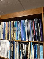 Top shelf of hardcovers showing aviation titles
