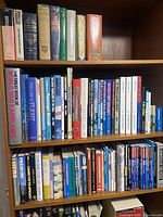 Entire bookcase shelves showing assorted aviation, travel and reference books