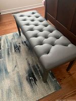 Top view of gray tufted bench showing full cushion
