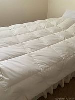 Full view of white box-stitched duvet on bed