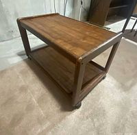 Full view of faux wood two-tier cart on casters