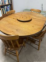 oval pine table with lazy susan and four chairs