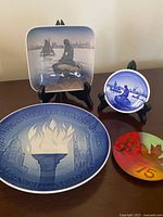 All four miniature plates displayed on stands