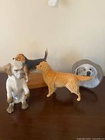 All three ceramic dog figurines on tabletop