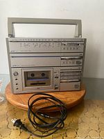 Front view of JVC PC-5 boombox on stand with power cord
