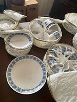 Overview of set in quilted storage cases showing plates, cups and saucers