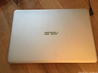 Closed silver Asus laptop top view