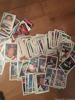 Spread of sleeved 1988 Topps baseball cards on floor