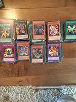 Overview of multiple stacks of Yu-Gi-Oh! cards sorted by type