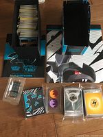 Card boxes, guide, play-mat and sealed accessories laid out