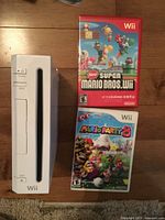 Front view of Nintendo Wii console with two game cases
