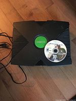 Top view of Xbox console with GTA disc on top