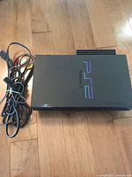 PS2 console top view with cables bundled