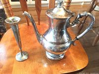 teapot beside candle holder on table