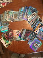 Tabletop spread of numerous blue Dazzlers and assorted foil Upper Deck hockey insert cards