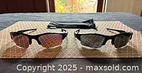 Both pairs of Oakley sunglasses with pouch