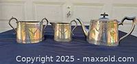 Full view of three-piece silver-plated tea set