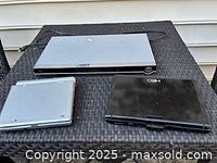 Three DVD players on wicker table