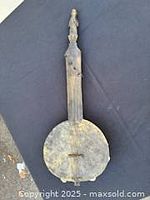 Full view of instrument showing carved neck and gourd body