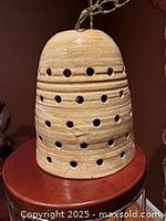 Side view of ceramic beehive lamp on surface